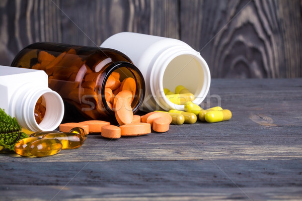 Various pills and containers with green leaves Stock photo © viperfzk