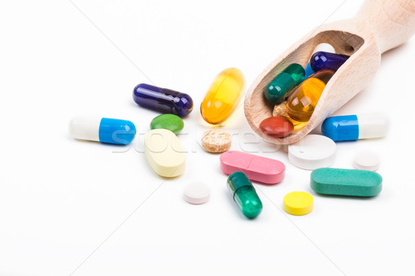 Color pills with wooden dispencer Stock photo © viperfzk