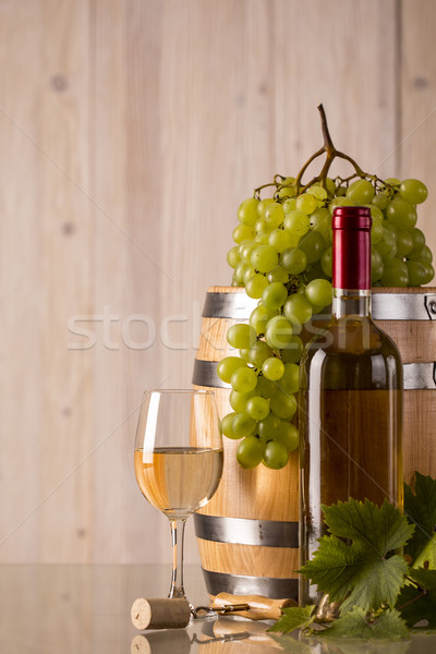 Glass of wine with a barrel and grapes Stock photo © viperfzk