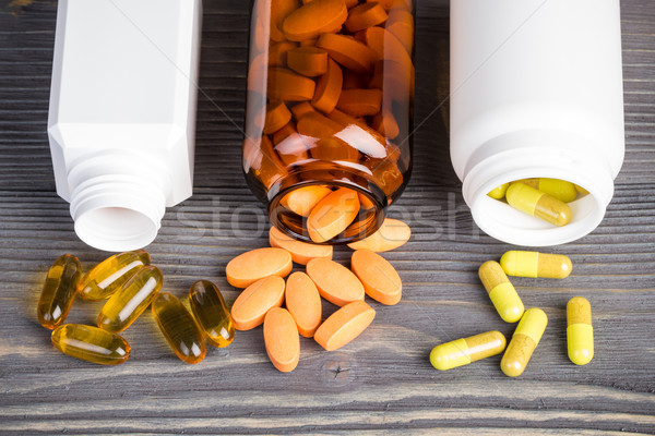 Stock photo: Various medicine pills on gray wooden surface