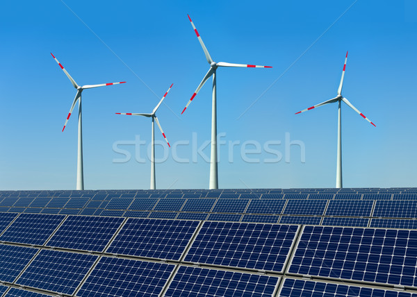 Wind turbines and solar panels against a blue sky Stock photo © visdia