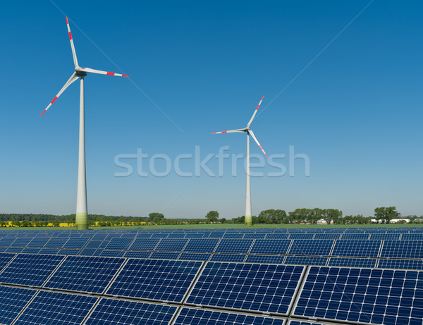 Solar panels and wind turbines against a rapeseed field Stock photo © visdia