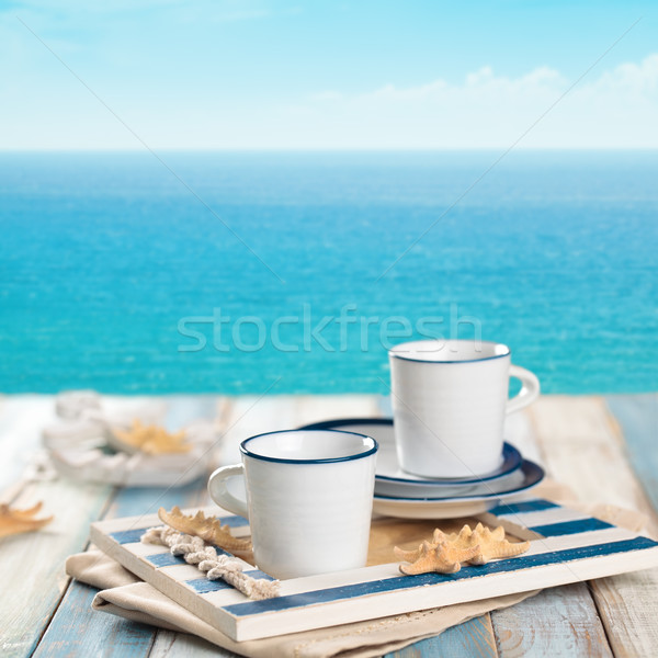 Beker koffiekopje koffie houten tafel Blauw zee Stockfoto © Vitalina_Rybakova