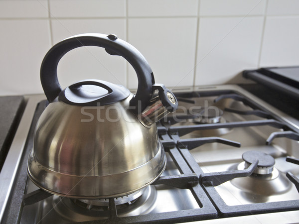 Tea kettle with boiling water on gas stove, Stock image