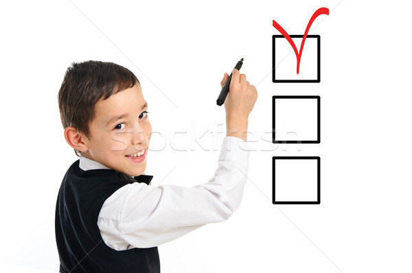 school boy wrighting checkboxes with pen isolated on white Stock photo © vkraskouski