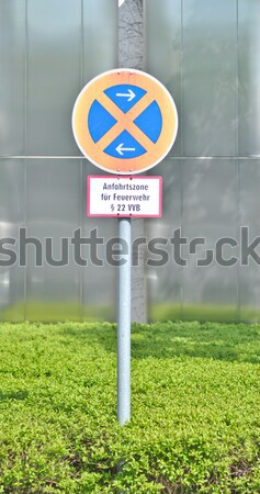 Traffic sign 'the stop is forbidden' against office building Stock photo © vlaru
