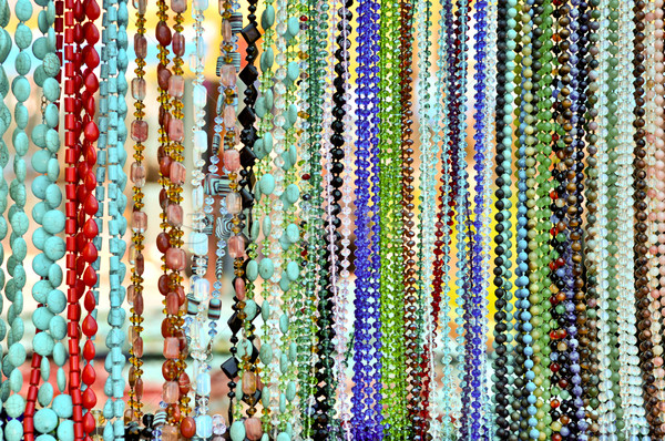 lots of colorful glass and stone beads hanging in a row Stock photo © vlaru