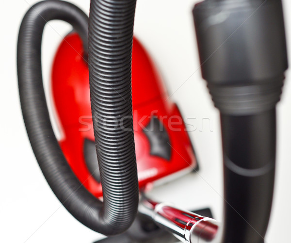 The red vacuum cleaner with a black hose on a white background
 Stock photo © vlaru