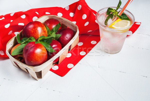 Cold fresh lemonade and nectarines on wood background Stock photo © voloshin311