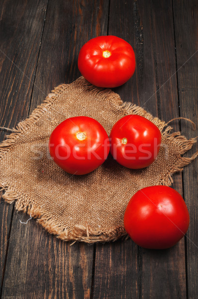 Close-up of fresh, ripe tomatoes on wood background Stock photo © voloshin311