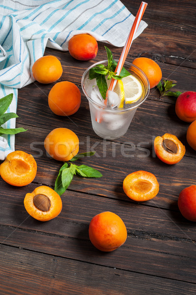 Cold fresh lemonade and apricots on wood background Stock photo © voloshin311