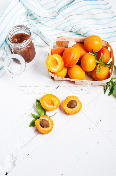 apricots in a basket and jam on white wood background Stock photo © voloshin311