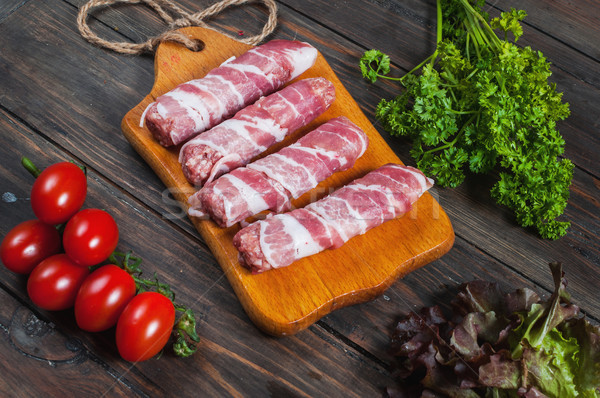 Bacon rolls with tomato, parsley on wooden background Stock photo © voloshin311