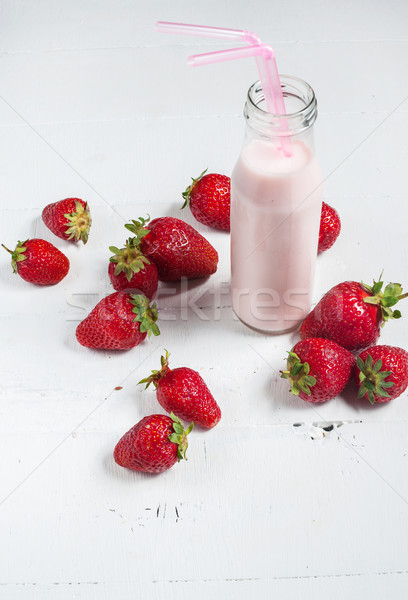 Strawberry yogurt with fresh strawberries on a white wooden background Stock photo © voloshin311