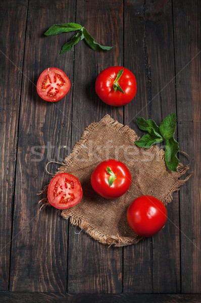 Close-up of fresh, ripe tomatoes on wood background Stock photo © voloshin311