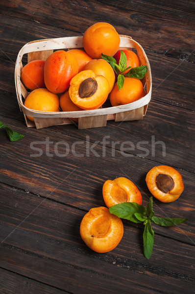apricots in a basket on dark wood background Stock photo © voloshin311