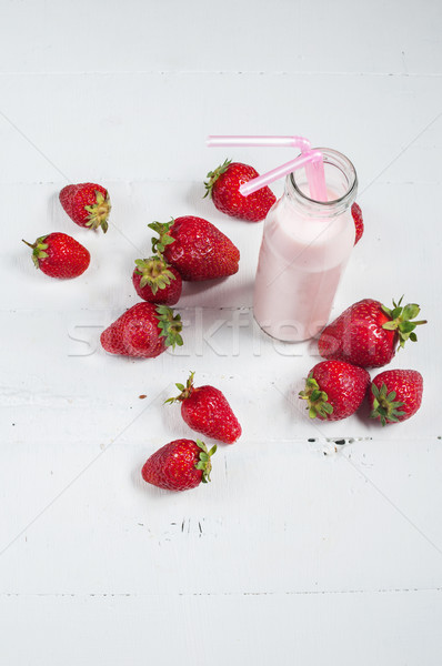 Strawberry yogurt with fresh strawberries on a white wooden background Stock photo © voloshin311