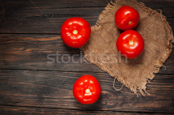 Close-up of fresh, ripe tomatoes on wood background Stock photo © voloshin311