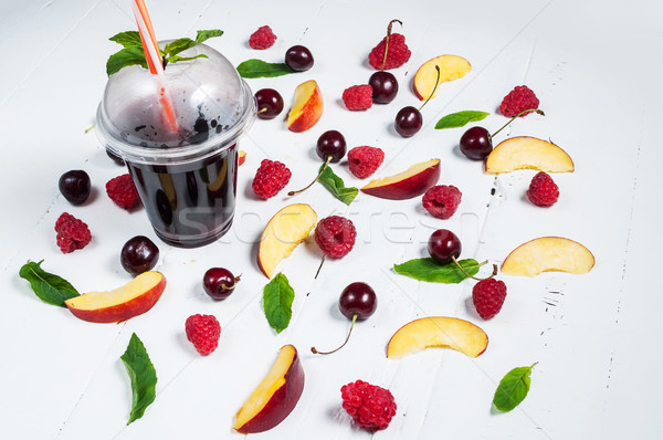 Various types of fruits with green leaves and frozen cocktail berries on white wood background Stock photo © voloshin311