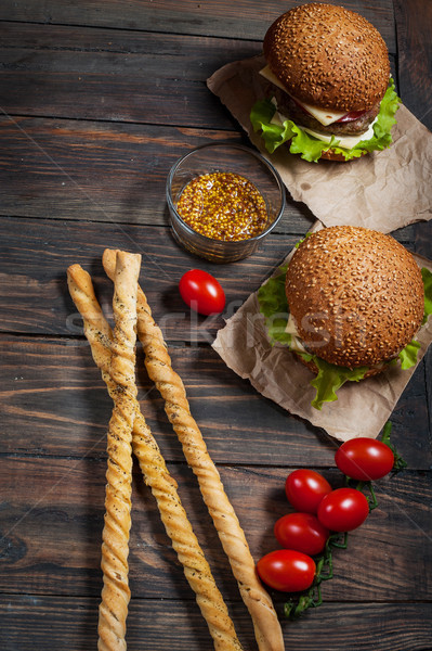 Fresh homemade burgers and breadsticks on wooden background Stock photo © voloshin311