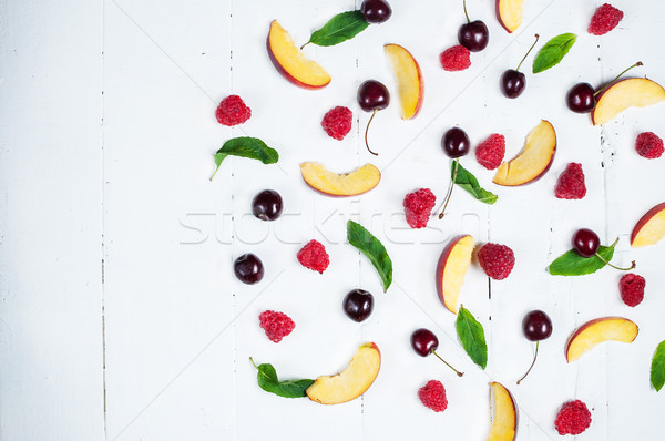 Various types of fruits with green leaves on white wood background Stock photo © voloshin311