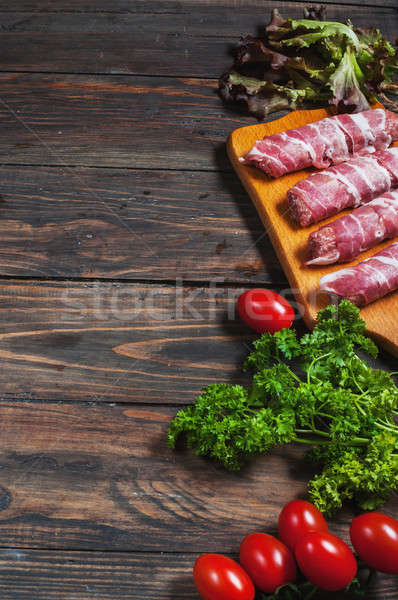 Bacon rolls with tomato, parsley on wooden background. Text place  Stock photo © voloshin311