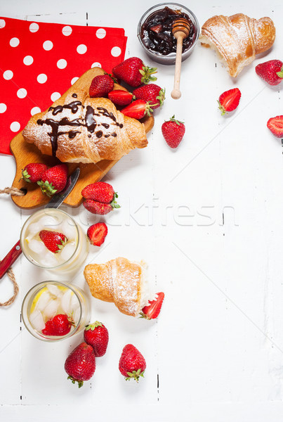 fresh croissants with lemonade and strawberries on white wooden background Stock photo © voloshin311