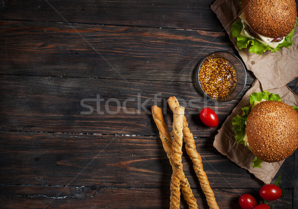 Fresh homemade burgers and breadsticks on wooden background Stock photo © voloshin311