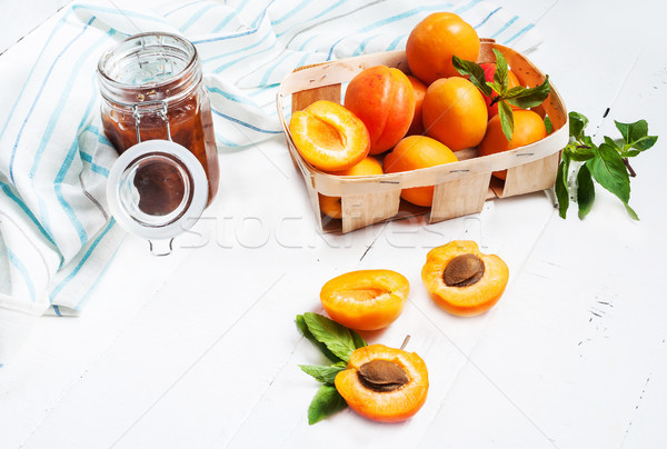 apricots in a basket and jam on white wood background Stock photo © voloshin311