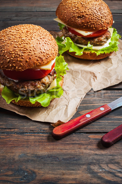 Fresh burger closeup on rustic wooden table. Stock photo © voloshin311