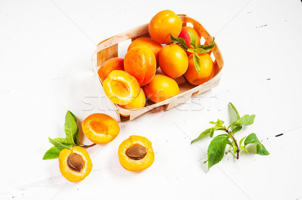 apricots in a basket on white wood background Stock photo © voloshin311