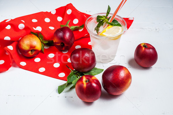 Cold fresh lemonade and nectarines on wood background Stock photo © voloshin311