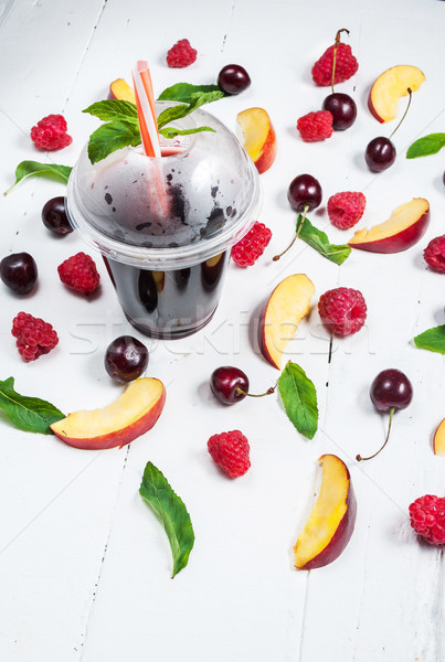 Various types of fruits with green leaves and frozen cocktail berries on white wood background Stock photo © voloshin311