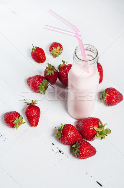 Strawberry yogurt with fresh strawberries on a white wooden background Stock photo © voloshin311