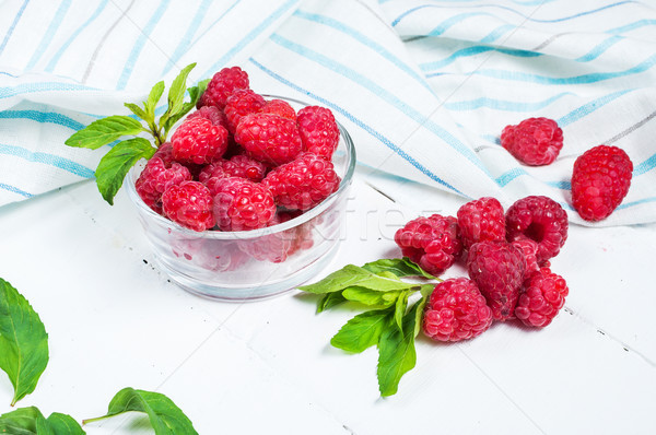 Ripe sweet raspberries in bowl on wooden table. Close up Stock photo © voloshin311