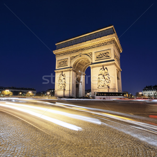Arc de Triomphe by night with car lights Stock photo © vwalakte