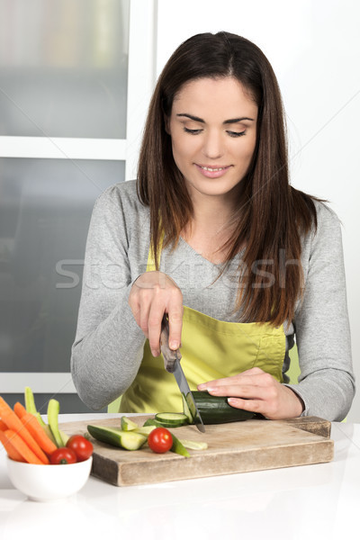 Beautiful woman cutting cucumber Stock photo © vwalakte