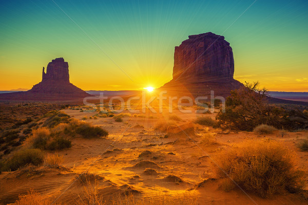 Sunset at the sisters in Monument Valley Stock photo © vwalakte