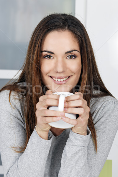 woman at home sipping tea from a cup Stock photo © vwalakte