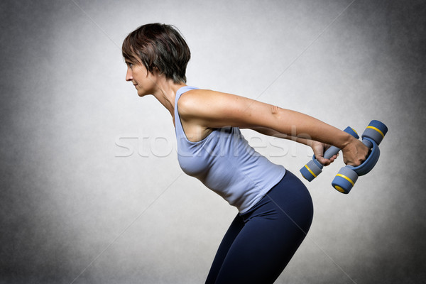 Middle aged woman with dumbbells Stock photo © w20er