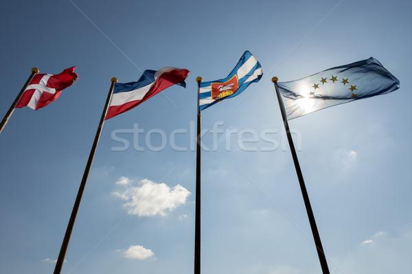 Blue sky with four flags Stock photo © w20er