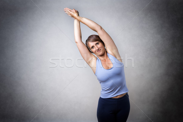 Middle aged woman doing stretching Stock photo © w20er