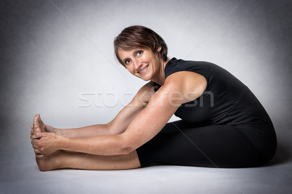 Stock photo: Middle aged woman doing stretching