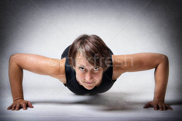 Middle aged woman doing push-ups Stock photo © w20er