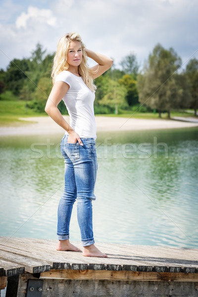 Blond woman standing on jetty Stock photo © w20er