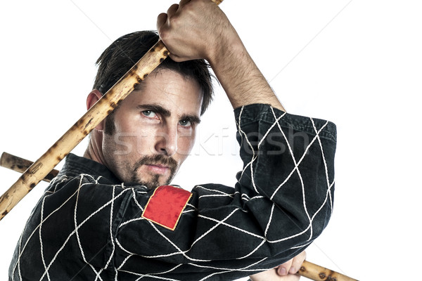 Martial arts master with bamboo sticks Stock photo © w20er