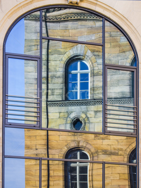 Mirroring of a old house in window Stock photo © w20er