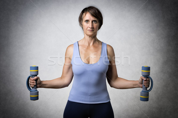 Middle aged woman with dumbbells Stock photo © w20er