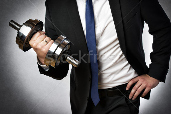 Stock photo: businessman with dumbbell