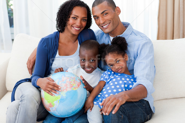 Afro-american family holding a terrestrial globe Stock photo © wavebreak_media